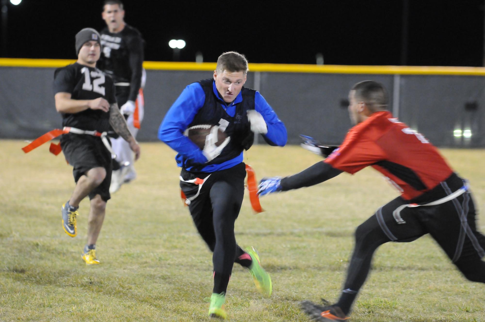 Daniel Hadley, 90th Security Forces Group Tactical Response Force, attempts to run past a defender Oct. 21 during the intermural flag football championship game against the 90th Security Forces Squadron. The TRF team beat the SFS team 14 to 13. (U.S. Air Force photo by Lan Kim)
