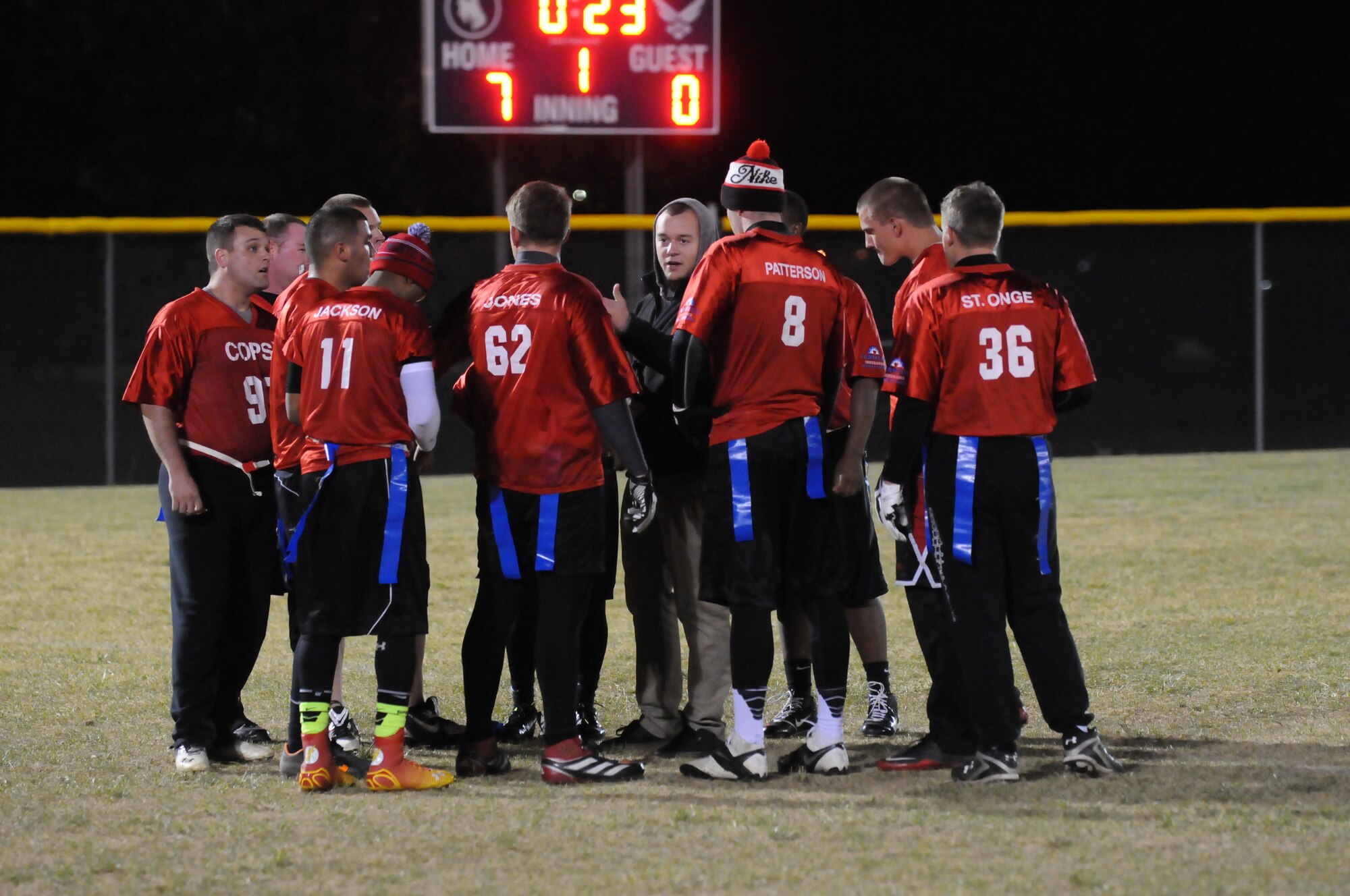 Ninetieth Security Forces Squadron Airmen huddle during the intermural flag football championship game Oct. 21, 2014, on F.E. Warren Air Force Base, Wyo. TRF won the game with a winning touchdown in the last minute. (U.S. Air Force photo by Lan Kim)