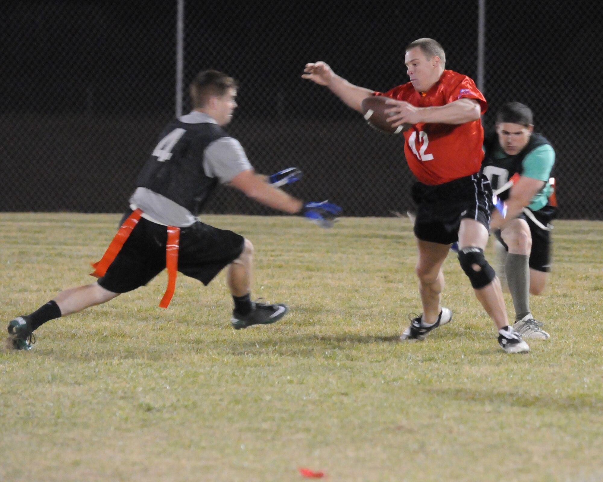Cameron Taylor, 90th Security Forces Squadron, maneuvers past 90th Security Forces Group Tactical Response Force defense Oct. 21 during the intermural flag football championship game. TRF won the game in the final minute with a winning touchdown. (U.S. Air Force photo by Lan Kim)