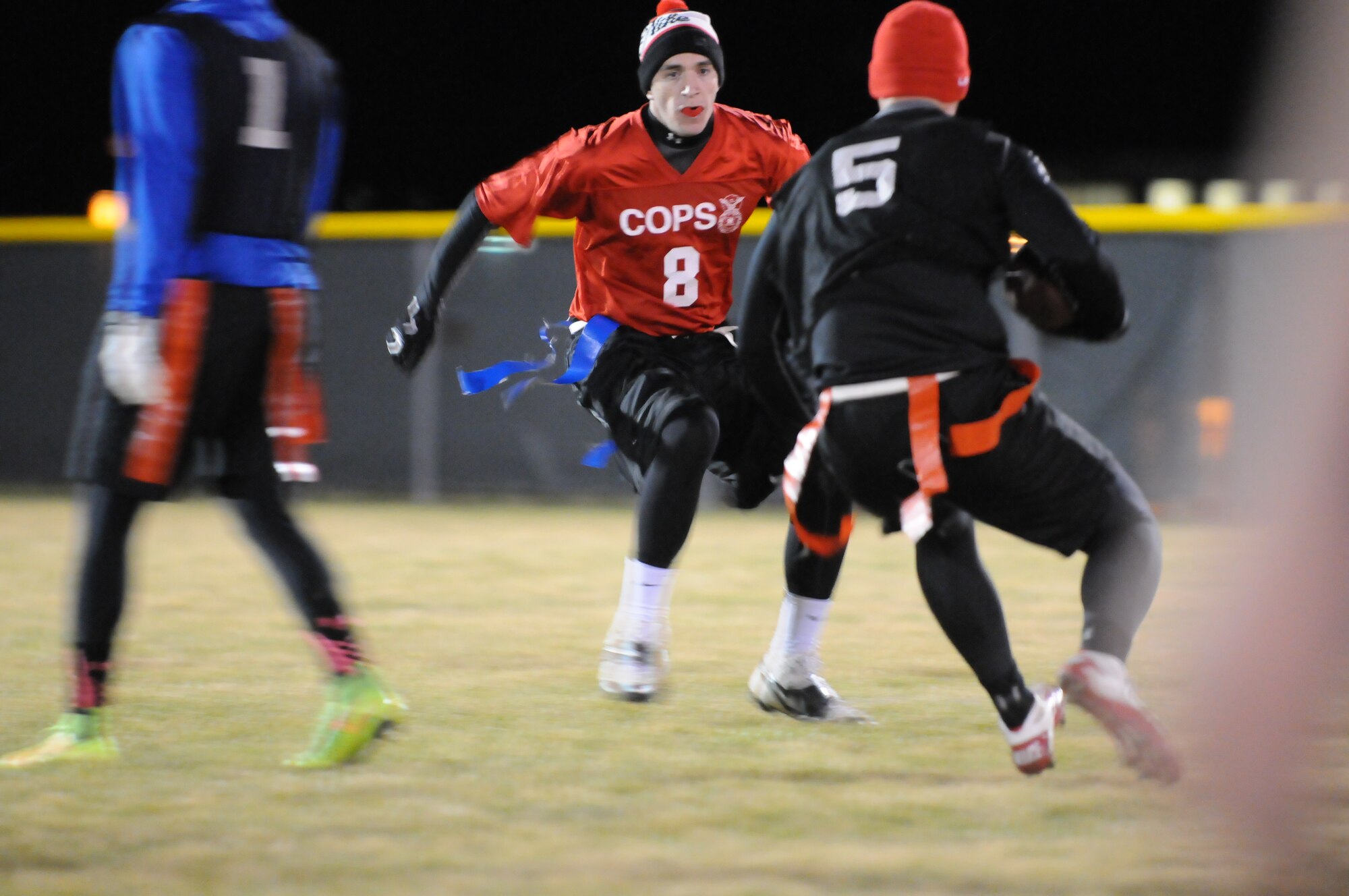 Bryan Patterson, 90th Security Forces Squadron, prepares to block a 90th Security Forces Group Tactical Response Force Airman Oct. 21 during the intermural flag football championship game. The game ran to the final minute of play, where the TRF  team scored the winning touchdown. (U.S. Air Force photo by Lan Kim)