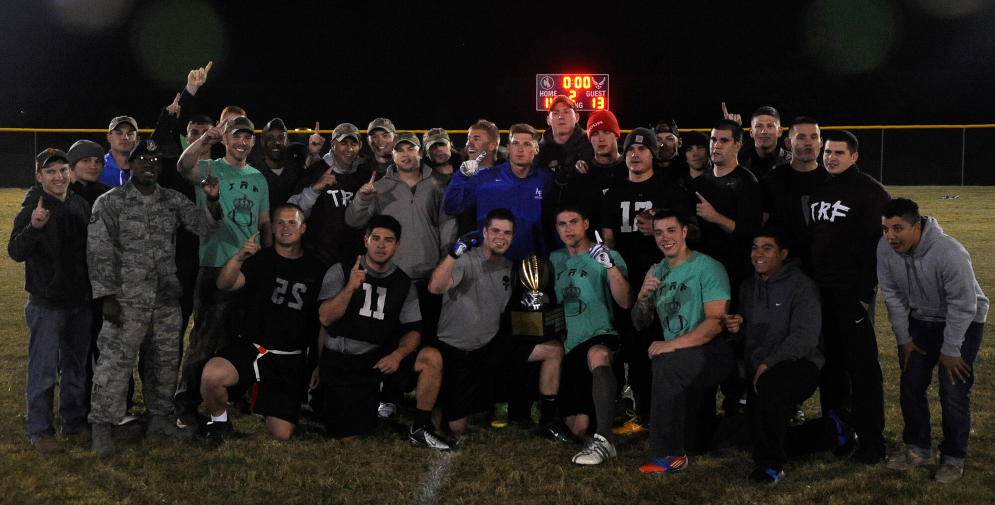 The 90th Security Forces Group Tactical Response Force intermural flag football team poses with fans after winning the championship game Oct. 21. The TRF team went undefeated throughout the season and were the defending champions coming into the game. (U.S. Air Force photo by Airman 1st Class Brandon Valle)

