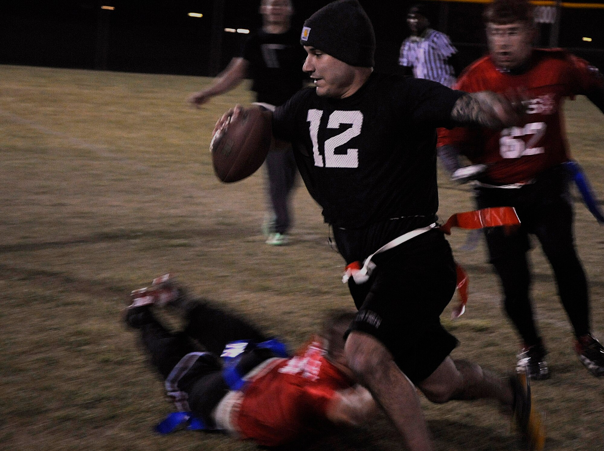 Brendan Darigan, 90th Security Forces Group Tactical Response Force, sprints past the 90th Security Forces Squadron defenders Oct. 21 during the intermural flag football championship game. The game ran to the final minute of play, where the TRF  team scored the winning touchdown. (U.S. Air Force photo by Airman 1st Class Brandon Valle) 
