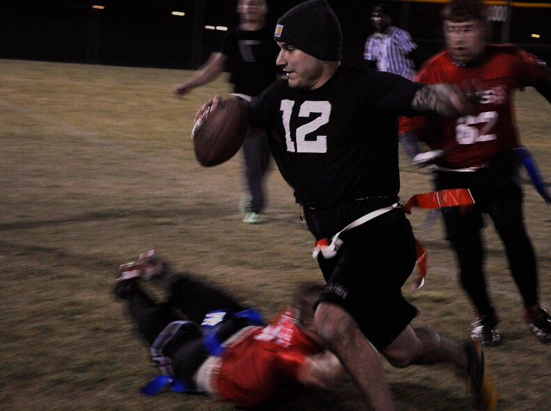 Brendan Darigan, 90th Security Forces Group Tactical Response Force, sprints past the 90th Security Forces Squadron defenders Oct. 21 during the intermural flag football championship game. The game ran to the final minute of play, where the TRF  team scored the winning touchdown. (U.S. Air Force photo by Airman 1st Class Brandon Valle) 
