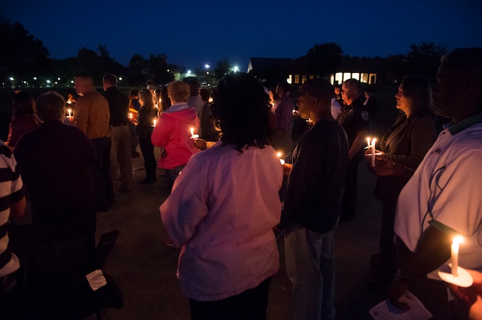 Attendees of the Candlelight Vigil hold candles in remembrance of domestic violence victims at the Municipal Building in Goose Creek, S.C., Oct. 21, 2014. The event was a demonstration of the military community effectively building relationships within the local community to promote awareness and combat domestic violence. (U.S. Air Force photo/Senior Airman George Goslin)
