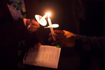 Candles are lit during the Domestic Violence Candlelight Vigil at the Municipal Building in Goose Creek, S.C., Oct. 21, 2014. The Candlelight Vigil was held in remembrance of the victims of domestic violence in South Carolina. The event was a demonstration of the military community effectively building relationships within the local community to promote awareness and combat domestic violence. (U.S. Air Force photo/Senior Airman George Goslin)