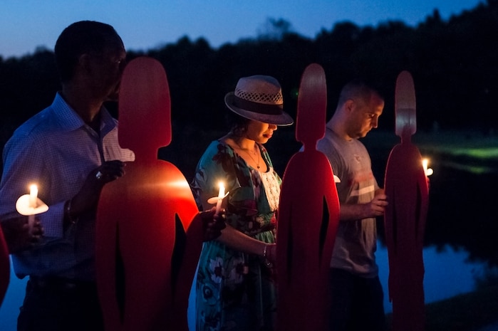Volunteers hold cardboard references to victims during the Candlelight Vigil at the Municipal Building in Goose Creek, S.C., Oct. 21, 2014. The cutouts were symbols of the victims who have perished due to domestic violence within the last year. The Candlelight Vigil was held in remembrance of the victims of domestic violence in South Carolina. (U.S. Air Force photo/Senior Airman George Goslin)