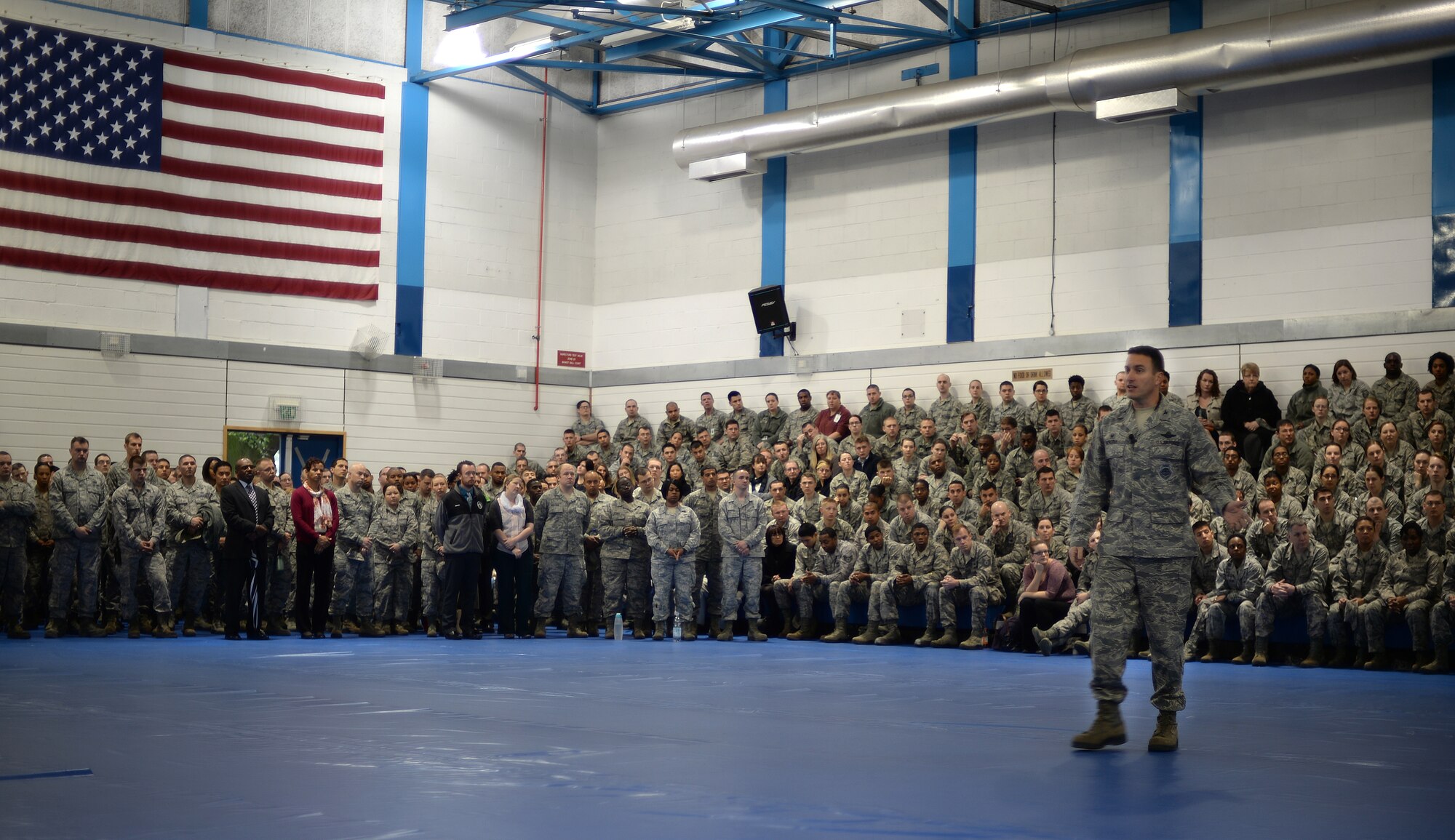 Col. Robert Novotny, 48th Fighter Wing commander, addresses Liberty Wing Airmen during a commander’s call at Royal Air Force Lakenheath, England. Novotny highlighted aspects the wing is excelling in and encouraged Airmen to improve their work processes. (U.S. Air Force photo by Staff Sgt. Emerson Nuñez/Released)   