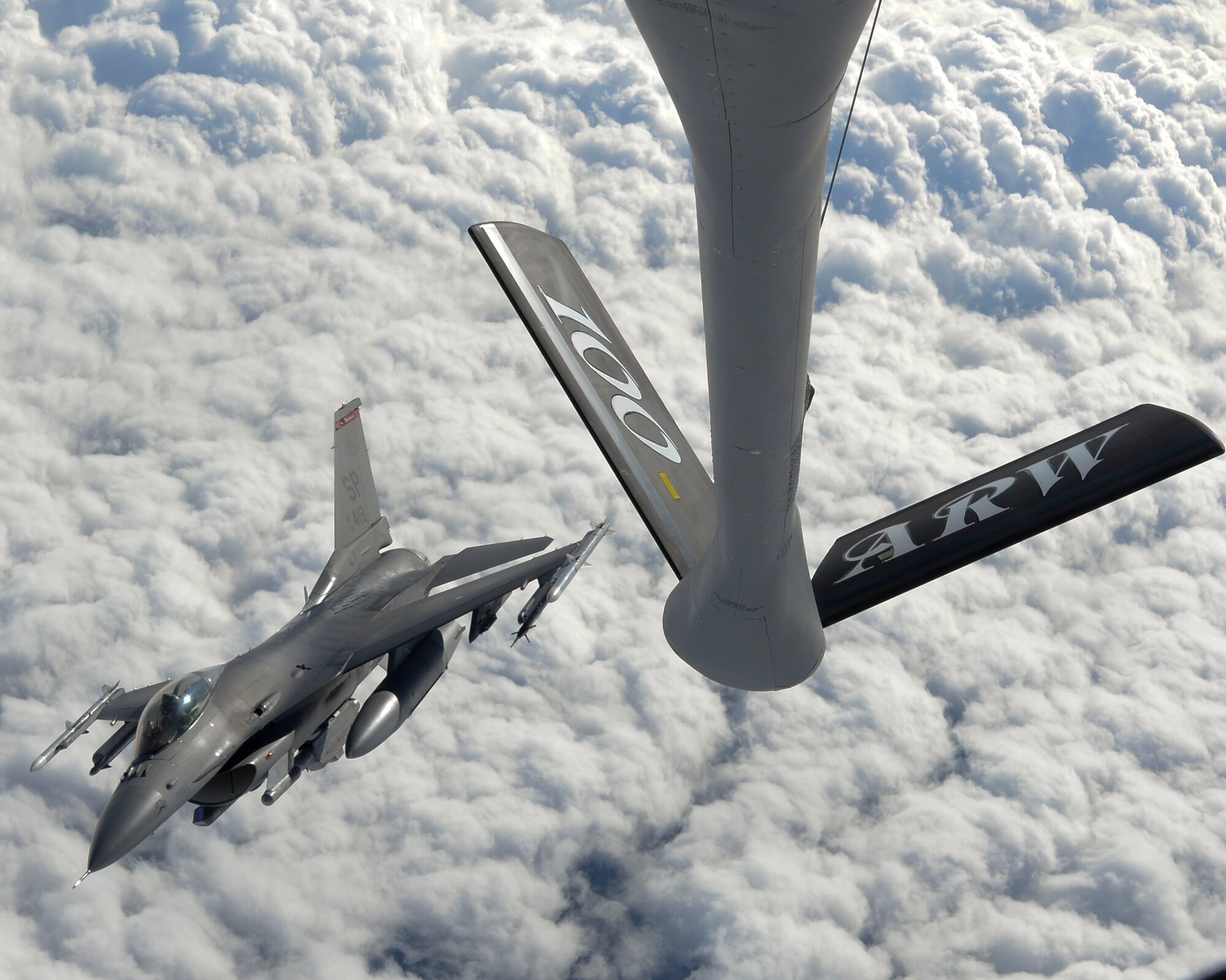 A U.S. Air Force F-16 Fighting Falcon from Spangdahlem Air Base, Germany, releases after receiving fuel from a KC-135 Stratotanker assigned to RAF Mildenhall, England, during the NATO-led exercise Noble Justification Oct. 21, 2014, hosted by Istres Air Base, France. The exercise demonstrates the possession of a rapid reaction capability within NATO, and highlights the interoperability of allied forces and the commitment of their nations. (U.S. Air Force photo/Senior Airman Victoria H. Taylor/Released)