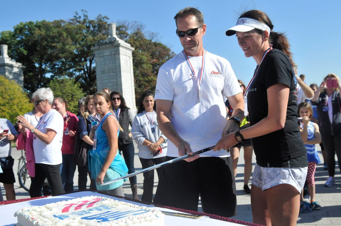 Navy Reserve Capt. Nancy Lacore and her husband Pat celebrate the completion of the 160-mile excursion called the Valor Run through Virigina from Memorial Bridge to the Women in Military Service for America Memorial in Washington, D.C., Oct. 18, 2014.