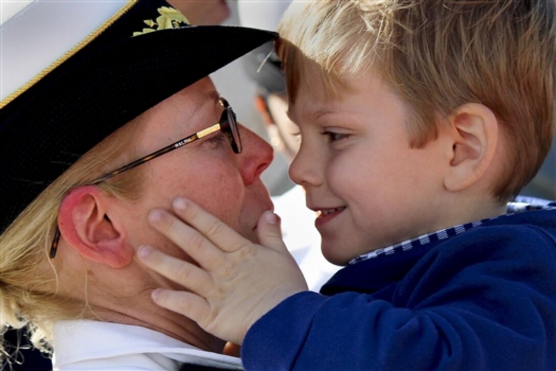 Navy Cmdr. Camille Flaherity hugs her son after returning to Norfolk, Va., from a deployment to the U.S. 5th and 6th Fleet areas of responsibility in support of maritime security operations, Oct. 17, 2014. Flaherity is the commanding officer of the guided-missile destroyer USS Arleigh Burke. 
