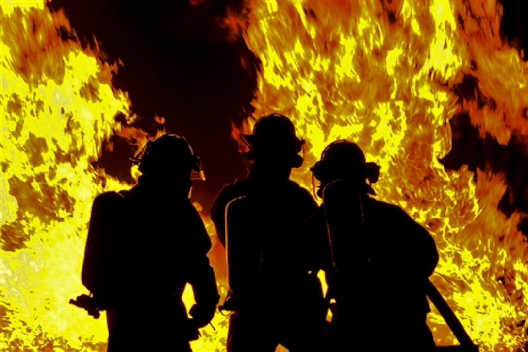 U.S. Air Force firefighters fight a controlled fire at Misawa Air Base, Japan, Oct. 9, 2014. The live fire demonstration allowed friends and family members to be educated and entertained as part of fire prevention week. 