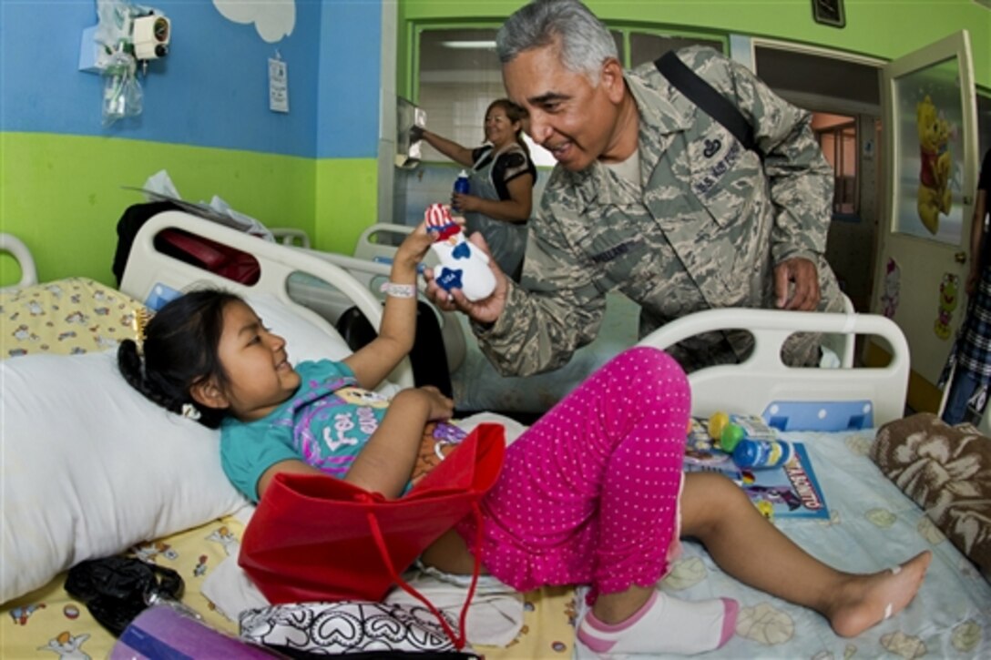 An airman visits the children’s ward to distribute gifts at the Leonardo Guzman Regional Hospital in Antofagasta, Chile, Oct. 11, 2014. The airman is assigned to the Texas Air National Guard’s 149th Fighter Wing.