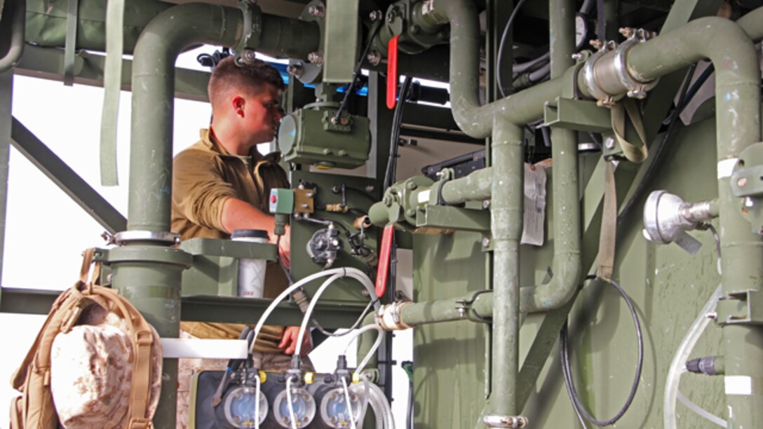 Lance Cpl. Joel Arndt, a water support technician with Marine Wing Support Squadron 373, monitors the gages of the Tactical Water Purification System at Marine Corps Base Camp Pendleton during exercise Pacific Horizon 2015, Oct. 23. PH 15 increases the ability of 1st Marine Expeditionary Brigade and Expeditionary Strike Group 3 to plan, communicate and conduct complex sea and shore based operations in response to natural disasters. (U.S. Marine Corps photo by Lance Cpl. Caitlin Bevel)