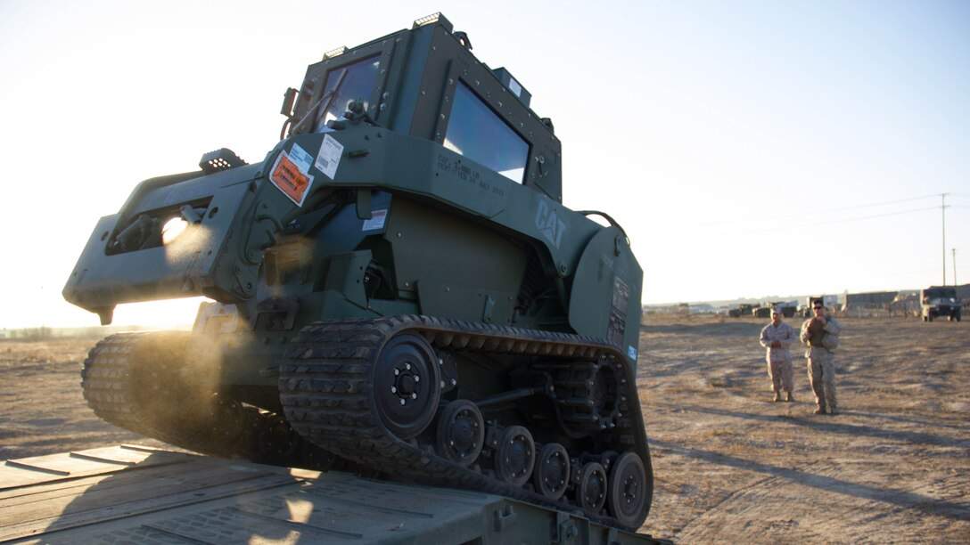 Marines with Marine Wing Support Squadron 373 offload heavy machinery into the staging area while performing a ship-to-shore drill during exercise Pacific Horizon 2015 aboard Marine Corps Base Camp Pendleton, Calif., Oct 23. PH 15 is a scenario driven, simulation supported crisis response exercise designed to improve 1st Marine Expeditionary Brigade's and Expeditionary Strike Group 3's interoperability and strengthen Navy-Marine Corps relations by conducting an in-stream Maritime Prepositioning Force offload of equipment by providing host country civil-military security assistance, and by conducting infrastructure restoration support from Oct. 20-28. 
