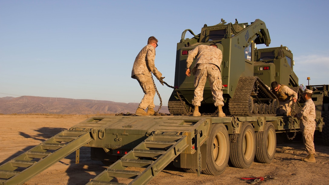 Marines with Marine Wing Support Squadron 373 prepare to offload heavy machinery into the staging area while performing a ship-to-shore drill during exercise Pacific Horizon 2015 aboard Marine Corps Base Camp Pendleton, Calif., Oct 23. PH 15 is a scenario driven, simulation supported crisis response exercise designed to improve 1st Marine Expeditionary Brigade's and Expeditionary Strike Group 3's interoperability and strengthen Navy-Marine Corps relations by conducting an in-stream Maritime Prepositioning Force offload of equipment by providing host country civil-military security assistance, and by conducting infrastructure restoration support from Oct. 20-28. 