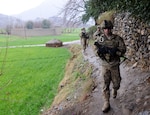 Pfc. Joshua E. Tomblin, Staff Sgt. Kevin J. Imholt, and 1st Lt. Thomas J. Goodman, all with 3rd Platoon, 12th Infantry Regiment, 4th Brigade Combat Team, lead a patrol through the Wata Poor district in Afghanistan. The Soldiers are wearing the Army's new uniform pattern for Afghanistan.
