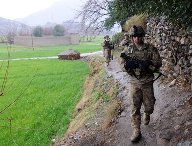 Pfc. Joshua E. Tomblin, Staff Sgt. Kevin J. Imholt, and 1st Lt. Thomas J. Goodman, all with 3rd Platoon, 12th Infantry Regiment, 4th Brigade Combat Team, lead a patrol through the Wata Poor district in Afghanistan. The Soldiers are wearing the Army's new uniform pattern for Afghanistan.