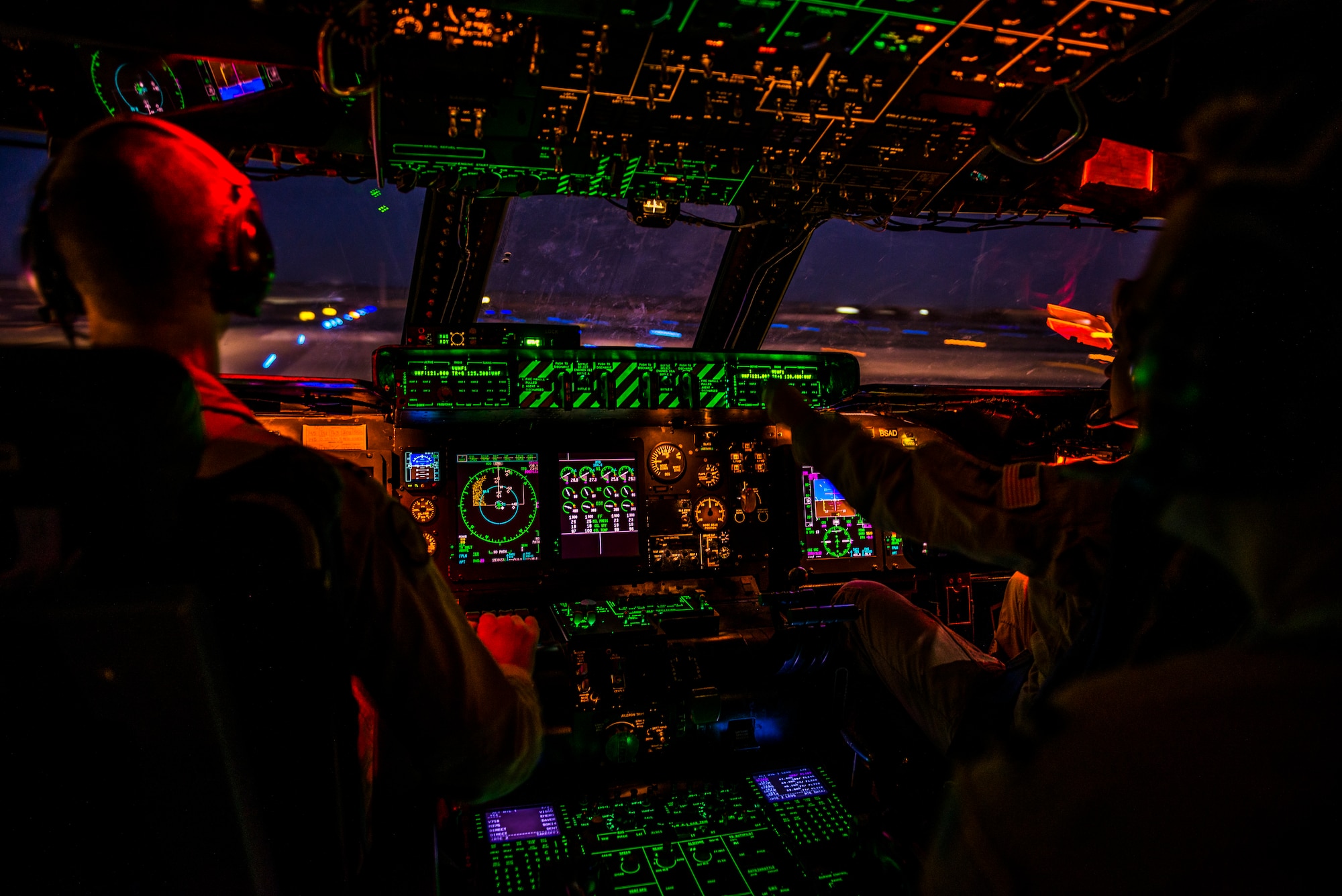 U.S. Air Force Capts. Matthew Upchurch (left) and Jennifer Nolta (right), 9th Airlift Squadron C-5M Super Galaxy pilots, take-off Oct. 6, 2014, from Camp Bastion, Afghanistan. Airmen from the 9th AS transported more than 266,000 pounds of cargo as part of retrograde operations in Afghanistan. Aircrews for the retrograde operations are managed by the 385th Air Expeditionary Group Detachment 1 and this flight surpassed 11 million pounds of cargo transported in a 50-day timespan. During this time frame, crews under the 385th AEG broke Air Mobility Command’s operational cargo load record five times. The heaviest load to date is 280,880 pounds. (U.S. Air Force photo by Staff Sgt. Jeremy Bowcock)