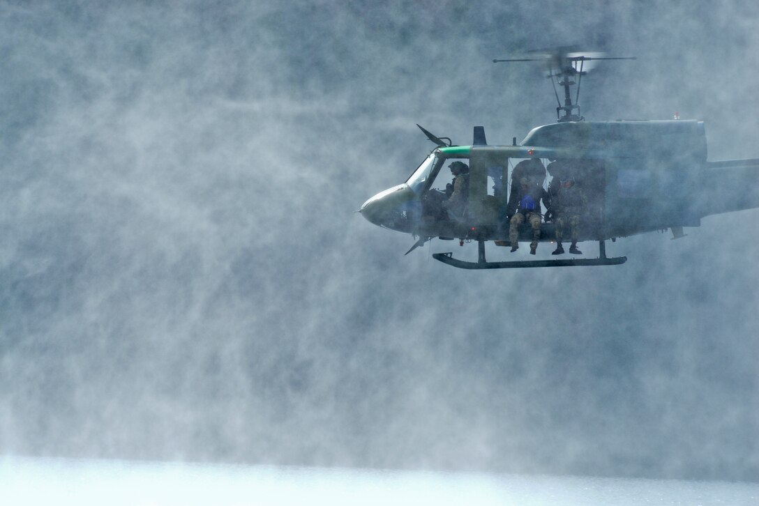 An UH-1N Iroquois hovers 10 feet above water looking for a potential landing zone during water operations training Oct. 17, 2014, at Long Lake, Wash. During the training, pilots and aircrew engineers from the 36th Rescue Flight at Fairchild Air Force Base, Wash., recertified on water rescue operation procedures. The 36th RQF supports the U.S. Air Force Survival School training through hands-on helicopter operations for more than 3,000 students per year. (U.S. Air Force photo/Staff Sgt. Alexandre Montes)