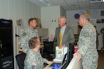 Staff members of the North Dakota National Guard discuss solutions for possible scenarios involving spring flooding during a recent training exercise that involved nearly 50 people and took place at Fraine Barracks Joint Operations Center.