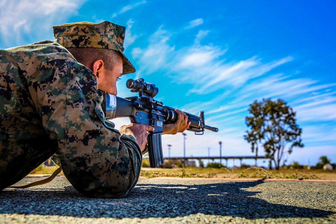 A recruit of Mike Company, 3rd Recruit Training Battalion, practices the marksmanship fundamentals of the prone position during Grass Week at Edson Range, Marine Corps Base Camp Pendleton, Calif., Oct. 15. During “snap-in-time,” recruits aimed in at barrels with targets painted on them simulating targets at different yard lines.