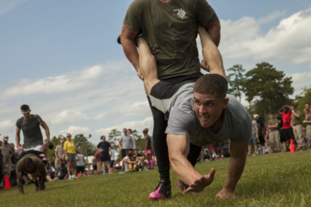 Marines compete in a wheelbarrow race as part of the team relay race.