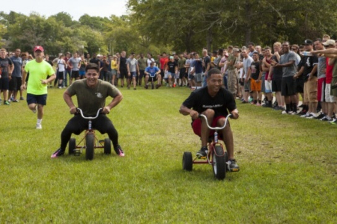 Marines compete in a tricycle race as part of the team relay race.

