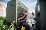 Air Force Senior Airman Courtnay Hester, a power production specialist with the Kentucky Air National Guard’s 123rd Contingency Response Group, sets up an electric generator to feed the Joint Operations Center at Léopold Sédar Senghor International Airport in Dakar, Senegal, Oct. 5, 2014, in support of Operation United Assistance. Hester and more than 80 other Kentucky Air Guardsmen stood up an Intermediate Staging Base at the airport that will funnel humanitarian supplies and equipment into West Africa as part of the international effort to fight Ebola. 