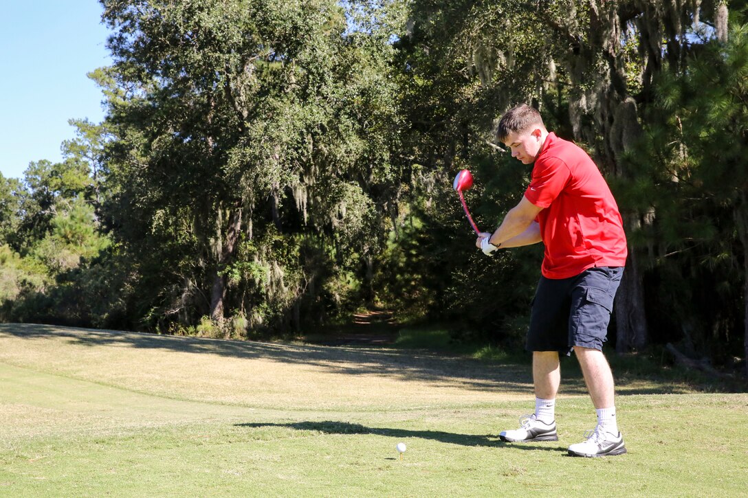 Lance Cpl. Sage Trevor begins his swing during the Red Ribbon golf tournament at The Legends, Oct. 17. The free tournament  promoted awareness of the negative effects drugs can have on individuals and communities for Red Ribbon Week. Red Ribbon Week is held each year in honor of Enrique Camarena, a Marine and drug enforcement agent who was killed in 1985 while reducing the amount of drugs trafficked into the United States. The theme this year is “Love yourself, be drug free,” and encourages community unity against drug abuse.