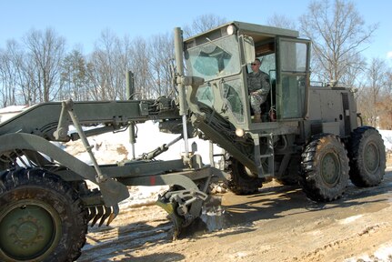 Sgt. James Riley of the West Virginia National Guard's 601st Engineer Company, uses a grader to help clear snow from Platt Mt. Lane in Inwood, W.Va., Feb. 19, 2010. Riley is one of 33 Soldiers, who volunteered for Stay Behind Force Dragon.