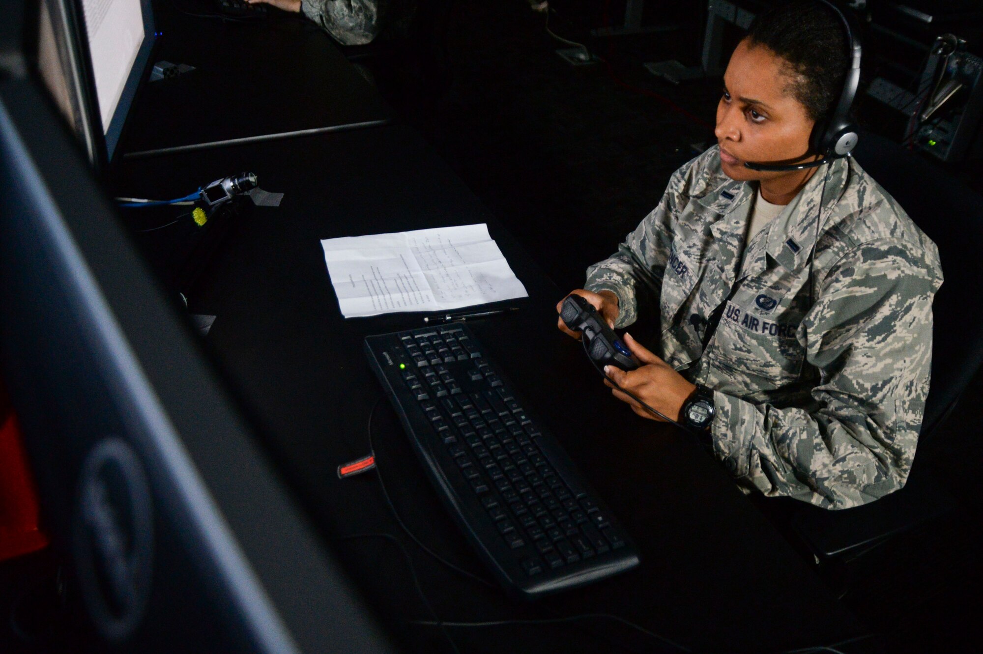First Lt. Kristin Spencer watches a video for suspicious behavior during a demonstration of a new Enhanced Reporting, Narrative Event Streaming Tool developed by the Air Force Research Laboratory Oct. 15, 2014, at Wright-Patterson Air Force Base, Ohio. The program aims to make intelligence analyst’s jobs easier by streamlining some of their routine tasks, which could enable to them save more lives. Spencer is a 711th Human Performance Wing behavioral scientist. (U.S. Air Force photo/Wesley Farnsworth)