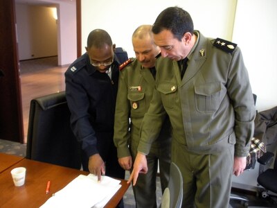 From left to right, Captain Terrence Kilgore, Air Force liaison officer with the U.S. Embassy in Tunisia, reviews exercise plans with Tunisian Forces Colonel Khaled Lamine and Lieutenant Colonel Khaled Baltage, January 2010. The three were taking part in a recent planning conference for a medical and disaster response exercise being coordinated by 17th Air Force (Air Forces Africa). The exercise, scheduled to take place in April, will include participation from the Wyoming Army and Air National Guard.