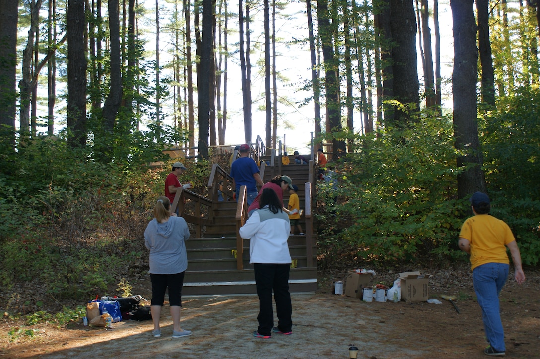 Volunteers paint the stairs at Buffumville Park, Charlton, Mass, for a National Public Lands Day event.