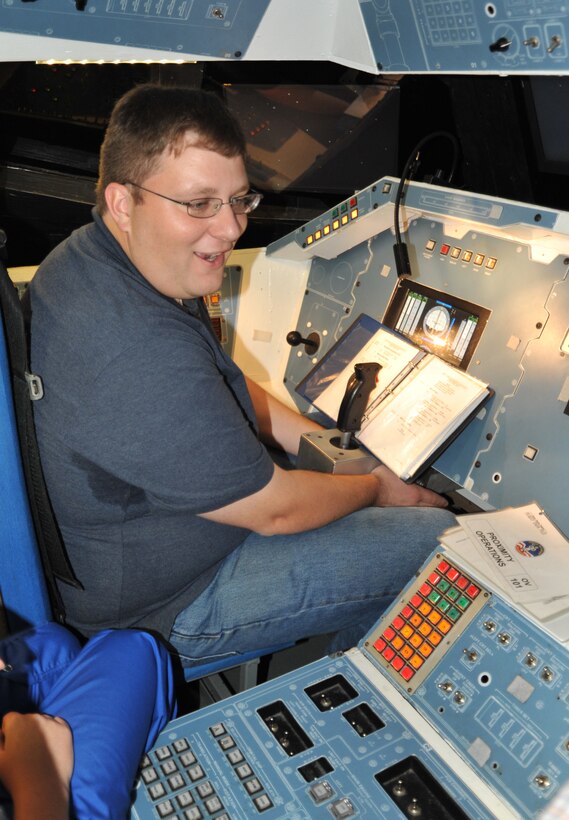 A member of U.S. Army Engineering and Sopport Center, Huntsville's Leadership Development Program II, Patrick Lane, takes control of the flight path of a a space shuttle mock-up during the space shuttle mission portion of the U.S. Space & Rocket Center's corporate camp Oct. 23. 