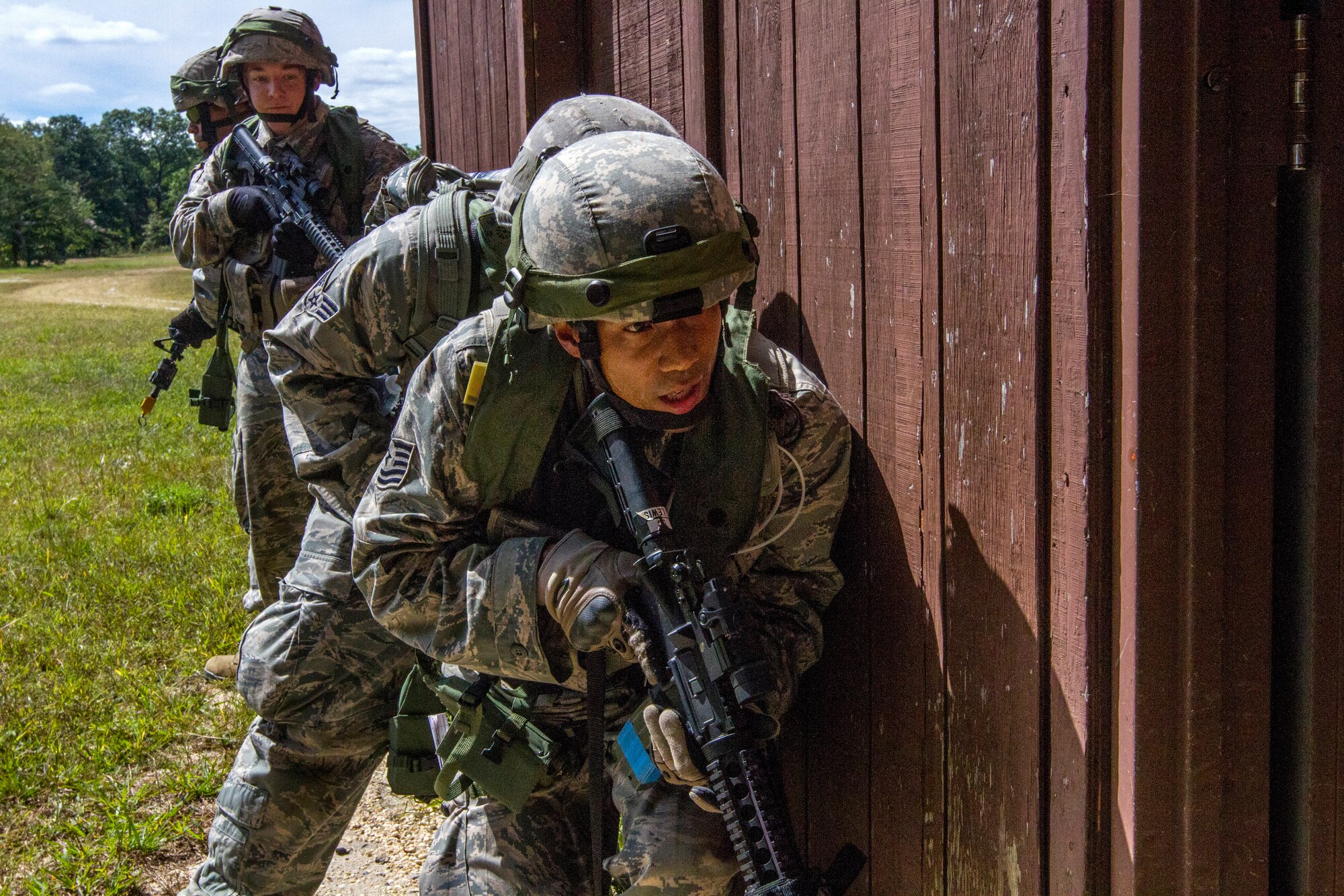 Airmen from the 108th Security Forces Squadron prepare to enter a building during an assault on opposing forces at an urban terrain facility at Joint Base McGuire-Dix-Lakehurst, N.J., Sept. 14, 2014. The Security Forces Airmen practiced land navigation, weapons proficiency and squad maneuvering tactics during September's unit training assembly. (U.S. Air National Guard photo by Master Sgt. Mark C. Olsen/Released)