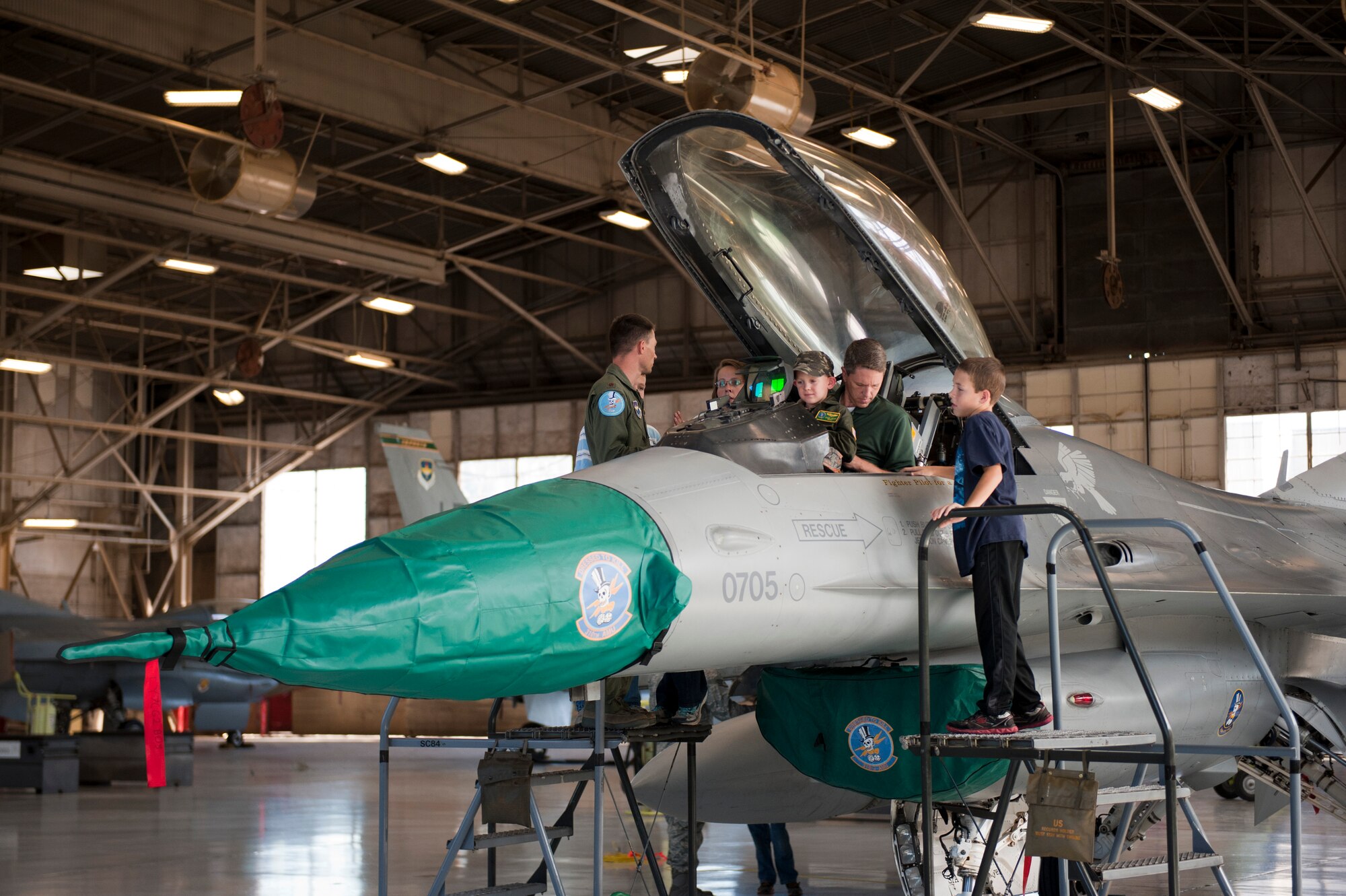 Daniel "Nanoo" Mayer, pilot for a day, sits in an F-16 Fighting Falcon cockpit with his dad, Jerry, at the 310th Fighter Squadron on Luke Air Force Base, Arizona, Oct. 24, 2014. The pilot for a day program focuses on children who have serious or chronic conditions and invites them to be a part of a flying squadron for an entire day. Mayer was diagnosed with Acute Lymphoblastic Leukemia two years ago and is currently in remission. (U.S. Air Force photo by Staff Sgt. Staci Miller)

