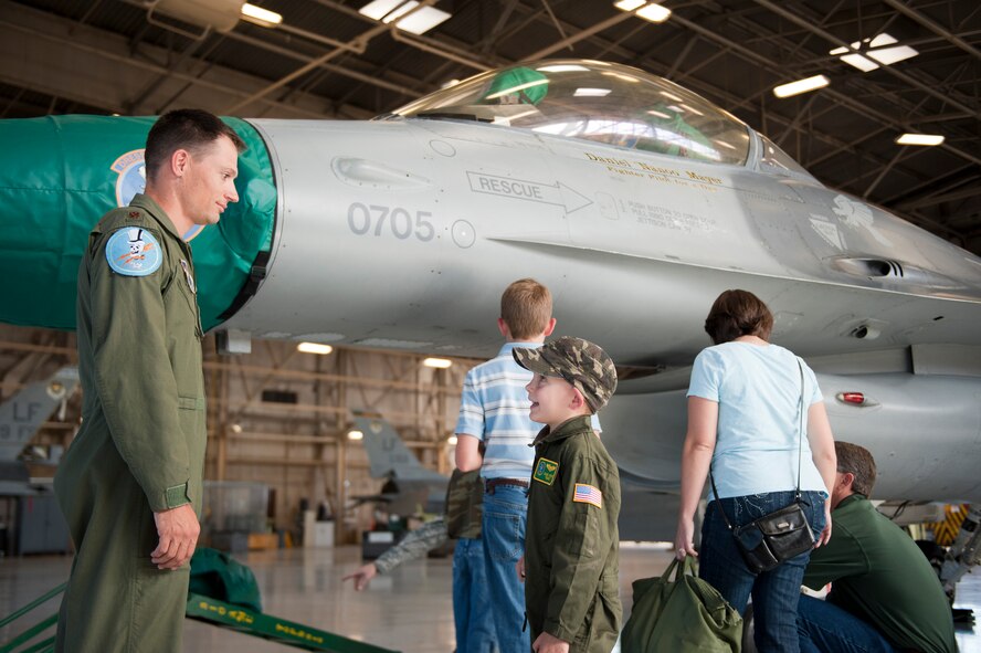 Daniel "Nanoo" Mayer, pilot for a day, talks with Maj. Nicholas Holmes, 310th Fighter Squadron fighter pilot, on Luke Air Force Base, Arizona, Oct. 24, 2014. The pilot for a day program focuses on children who have serious or chronic conditions and invites them to be a part of a flying squadron for an entire day. Mayer was diagnosed with Acute Lymphoblastic Leukemia two years ago and is currently in remission. (U.S. Air Force photo by Staff Sgt. Staci Miller)