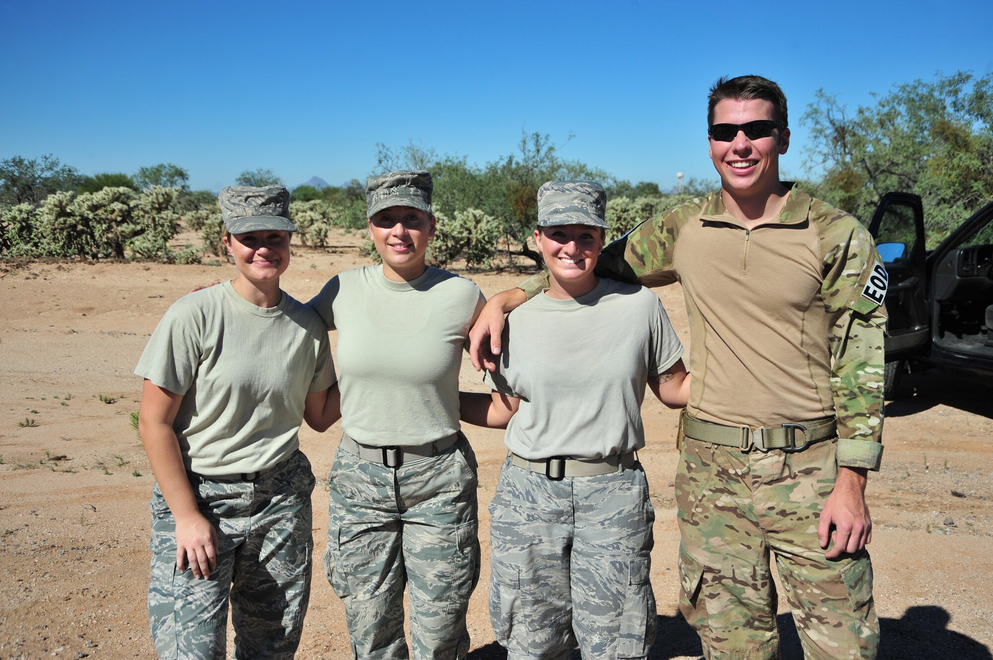 U.S. Air Force Staff Sgt. Kate Grady, 355th Aerospace Medicine Squadron bioenvironmental engineer technician, Airman 1st Class Sarah Walser, 355th Civil Engineer Squadron readiness and emergency management journeyman, Senior Airman Jenna Schaub, 355th CES readiness and emergency management journeyman, and Airman 1st Class Jeremy Seybold, 355th CES explosive ordnance disposal apprentice, pose for a photo after being the first team to complete all 12 tasks during an exercise at Davis-Monthan Air Force Base, Ariz., Oct. 23, 2014.  The purpose of the event was to build morale and test the participants’ knowledge and skills in an atmosphere that is both physically and intellectually challenging.  (U.S. Air Force Photo by Airman 1st Class Chris Massey/Released) 
