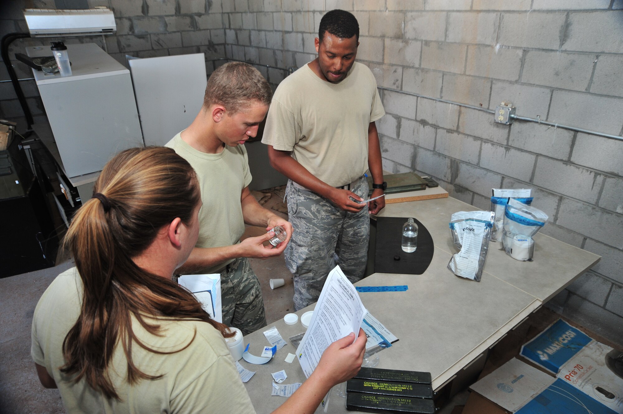 U.S. Air Force Staff Sgt. Ashley Jordan, 355th Aerospace Medicine Squadron bioenvironmental engineer journeyman, Airman 1st Class Alec Truesdell, 355th Civil Engineer Squadron emergency management apprentice, and Staff Sgt. Virgil Bandy, 355th Civil Engineer Squadron readiness and emergency management craftsman, work together to collect samples during a competition at Davis-Monthan Air Force Base, Ariz., Oct. 23, 2014.  This task tested the members’ ability to properly handle samples and avoid contamination.  (U.S. Air Force Photo by Airman 1st Class Chris Massey/Released)