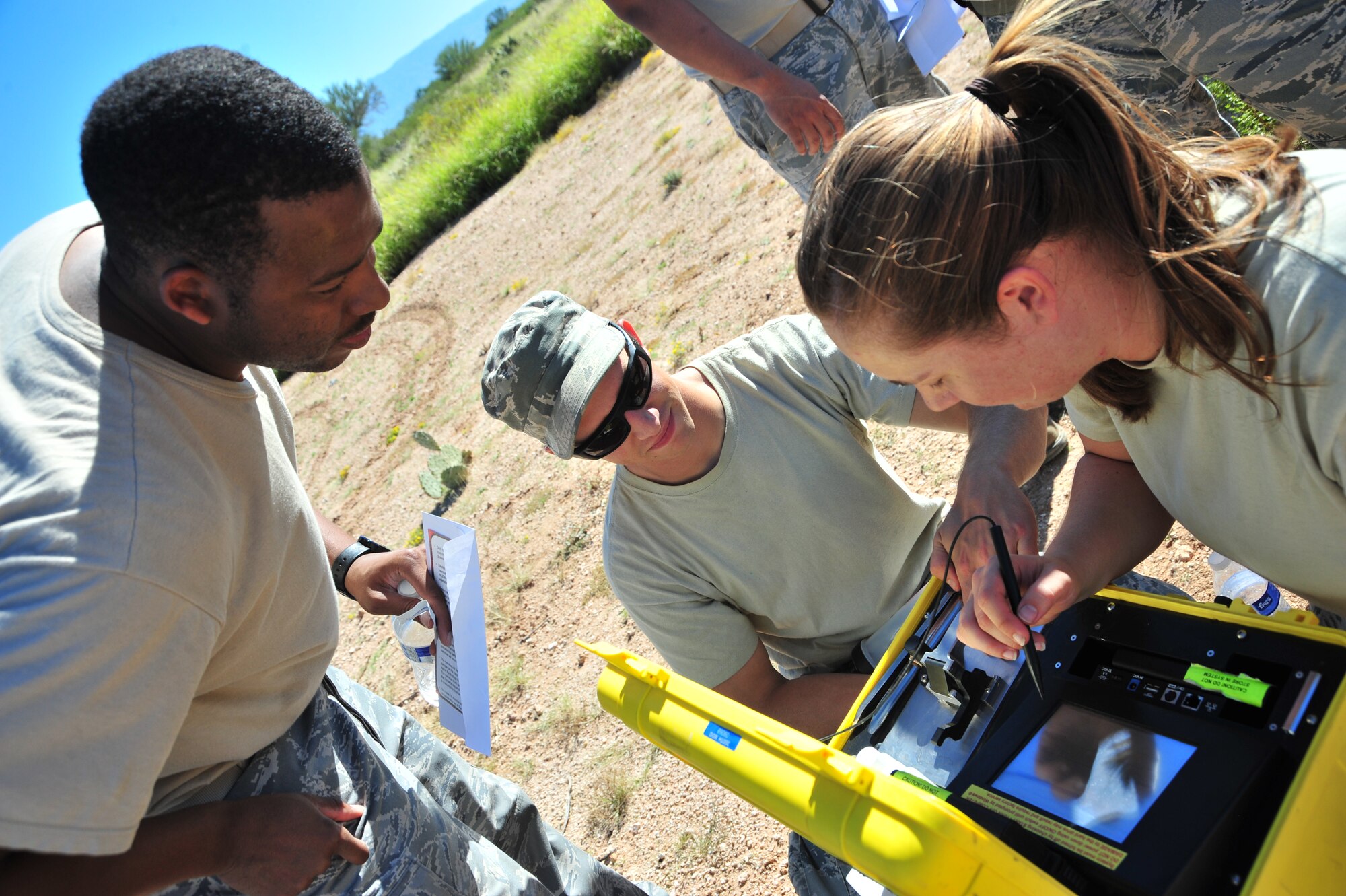 U.S. Air Force Staff Sgt. Ashley Jordan, 355th Aerospace Medicine Squadron bioenvironmental engineer journeyman, uses a portable solids and liquids identifier to test a substance during an exercise at Davis-Monthan Air Force Base, Ariz., Oct. 23, 2014.  Teams, comprised of four Airmen, needed to locate and complete 12 task stations in order to finish the competition-style exercise.  (U.S. Air Force Photo by Airman 1st Class Chris Massey/Released)
