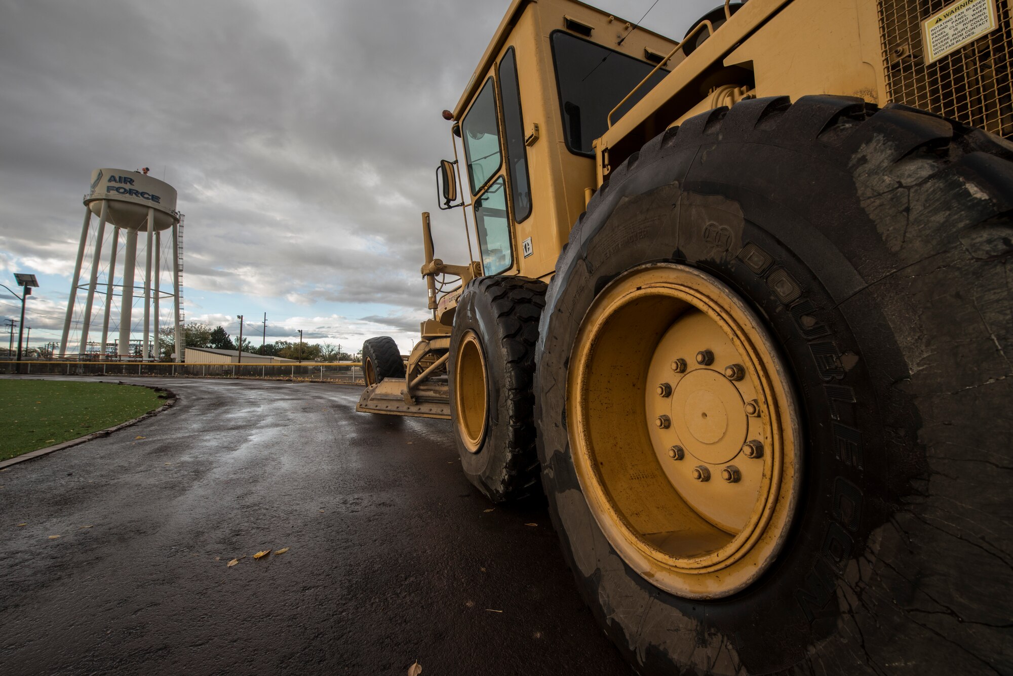 A motor grater peels the old layer of rubber off of the Health and Wellness Center track Oct. 21, 2014, at Mountain Home Air Force Base, Idaho. The track will receive a new cushioned layer aimed to lessen the effects on runners' knees. (U.S. Air force Photo by Airman Connor J. Marth/RELEASED)