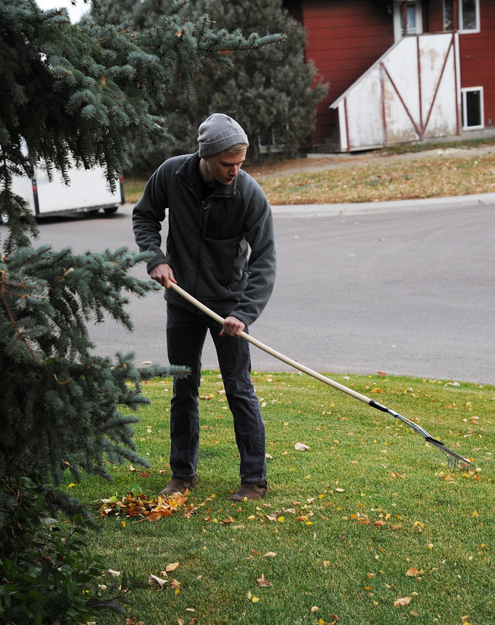 Airman 1st Class Zakery Lynch, 341st Munitions Squadron maintenance team member, rakes leaves at a house in Great Falls, Mont., during the Day of Caring Oct. 24. The Day of Caring is an annual event geared toward helping the elderly in the community with odd jobs and yard work around their homes. (U.S. Air Force photo/Christy Mason)
