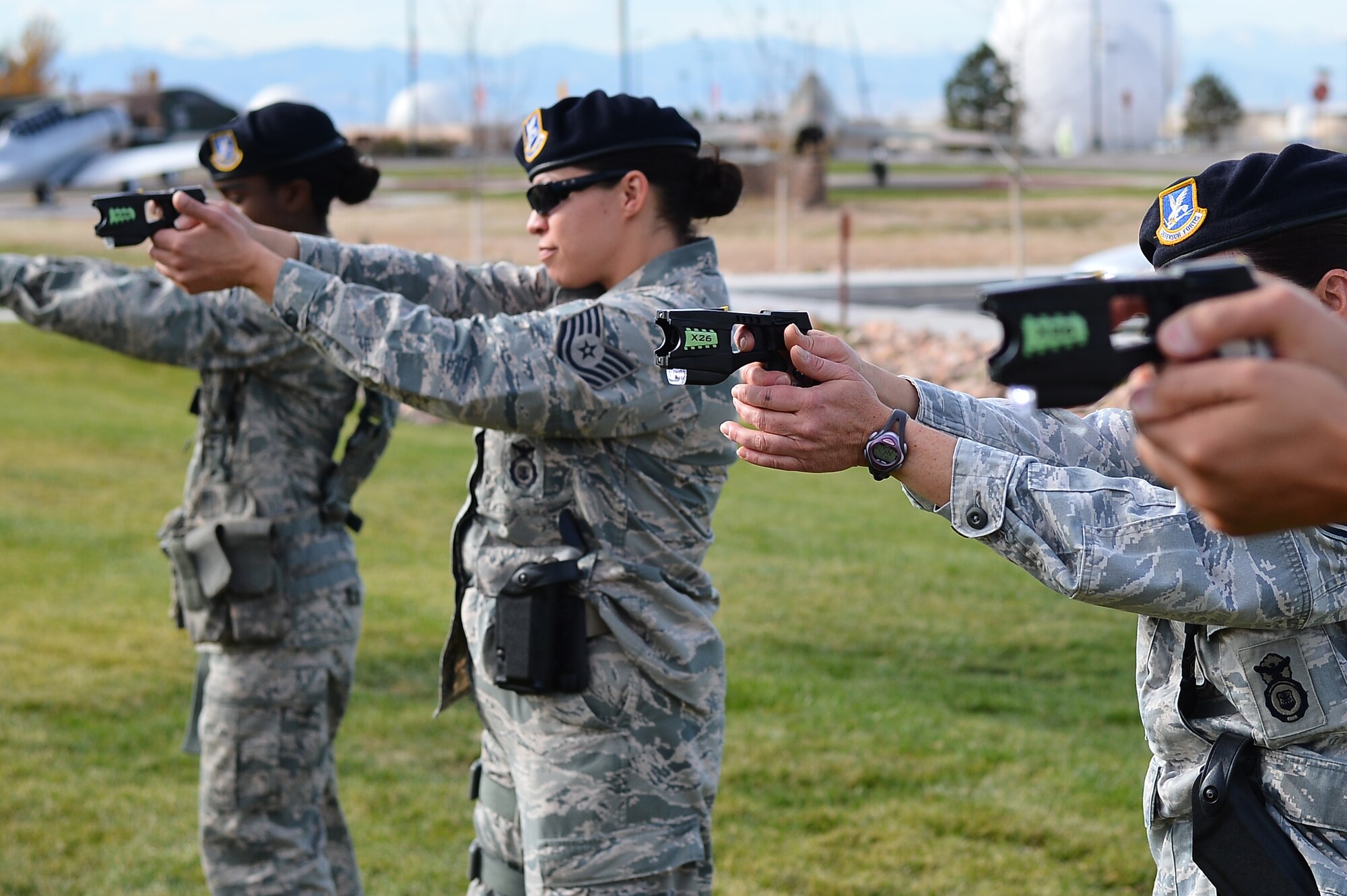 Members from the 140th Security Forces Squadron practice drawing their Conducted Electronic Weapons during training Oct. 23, 2014, at the 140th SFS building on Buckley Air Force Base, Colo. CEW training is designed to educate law enforcement members on when and how to use non-lethal force in stressful situations. (U.S. Air Force photo by Senior Airman Darren Scott/Released)