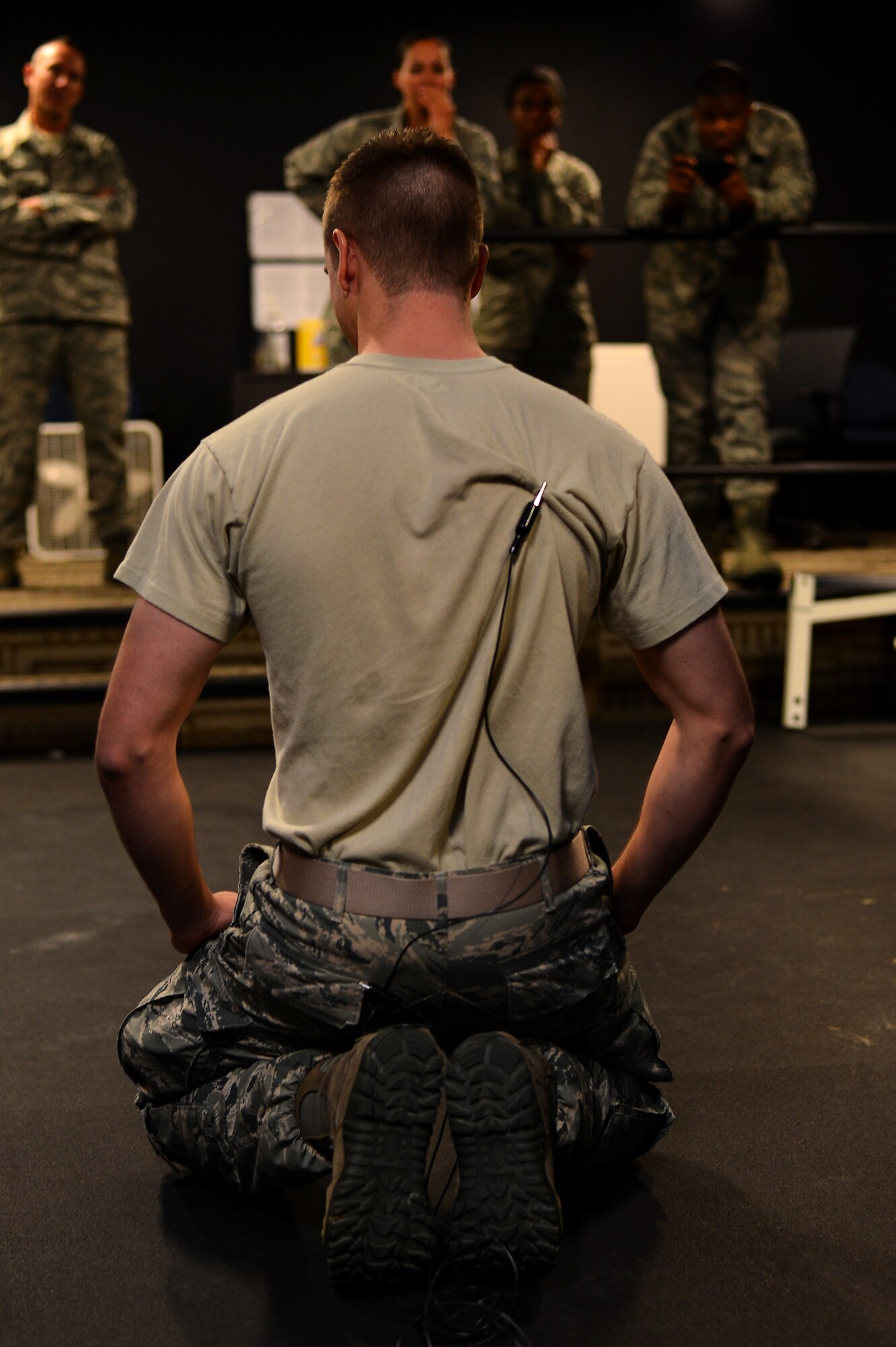 Airman 1st Class Matthew Coover, 140th Security Forces Squadron flight operator, prepares for his Conducted Electronic Weapons voluntary exposure Oct. 23, 2014, at the 140th SFS building on Buckley Air Force Base, Colo. CEW training is designed to educate law enforcement members on when and how to use non-lethal force in stressful situations. (U.S. Air Force photo by Senior Airman Darren Scott/Released)