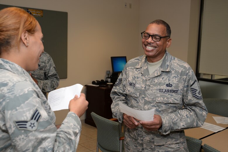 Master Sgt. Andre Gattis, NCO in charge of the dress and restoration section, and SrA Kaila Daniel, Fisher House manager on duty, learn more about each other through a series of questions designed to highlight cultural differences during Air Force Mortuary Affairs Operations Wingman Day Oct. 23, 2014. The round-robin Get to Know Your Wingman allowed people to learn more about one another and make a connection. (U.S. Air Force photo/Master Sgt. Christopher Gish)