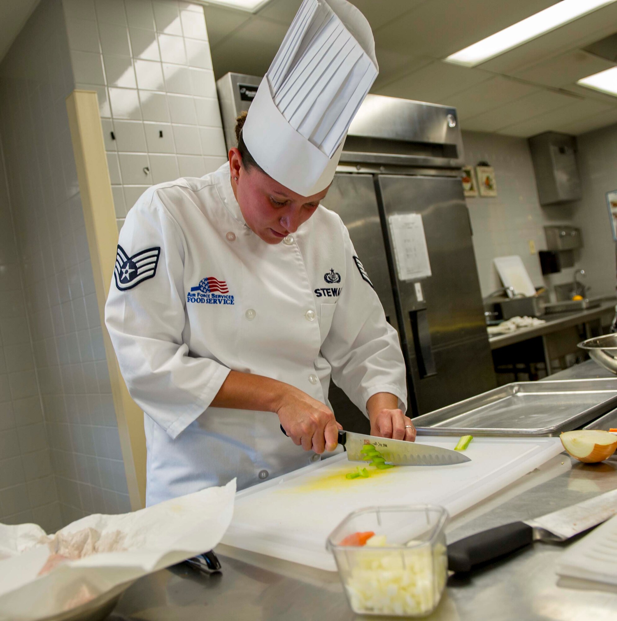 Staff Sgt. Sheryl Stewart, a 647th Force Support Squadron Airman assigned to the Joint Culinary Arts Team Hawaii, practices chopping techniques in the training kitchen at Schofield Barracks Oct. 22, 2014. Stewart will join 15 Soldiers, Sailors and Marines from around the island to face off in the annual Military Culinary Arts Competitive Training Event in Fort Lee, Va., next year. (U.S. Air Force photo by Tech. Sgt. Terri Paden)
