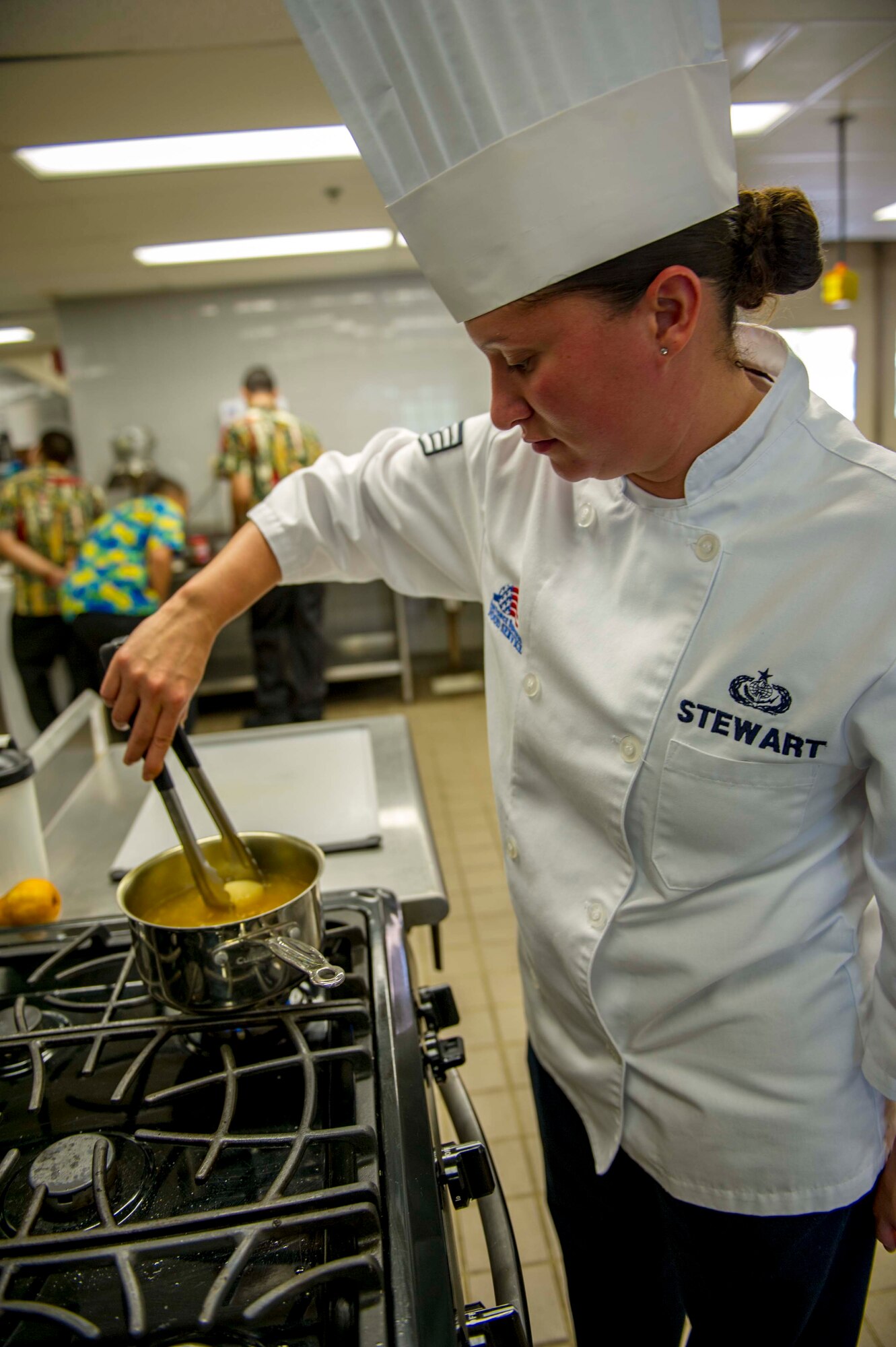 Staff Sgt. Sheryl Stewart, a 647th Force Support Squadron Airman assigned to the Joint Culinary Arts Team Hawaii, stirs a poached pear in the training kitchen at Schofield Barracks Oct. 22, 2014. Stewart will join 15 Soldiers, Sailors and Marines from around the island to face off in the annual Military Culinary Arts Competitive Training Event in Fort Lee, Va., next year. (U.S. Air Force photo by Tech. Sgt. Terri Paden)