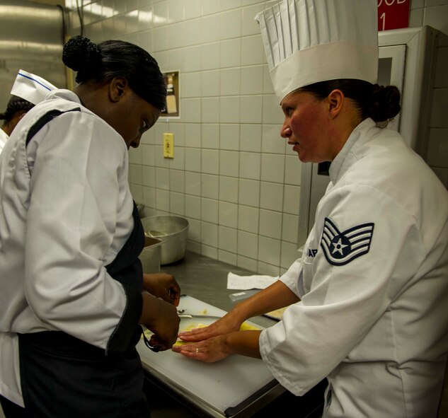 Staff Sgt. Sheryl Stewart, a 647th Force Support Squadron Airman assigned to the Joint Culinary Arts Team Hawaii, demonstrates how to properly cut and clean a pear in the training kitchen at Schofield Barracks Oct. 22, 2014. Stewart will join 15 Soldiers, Sailors and Marines from around the island to face off in the annual Military Culinary Arts Competitive Training Event in Fort Lee, Va., next year. (U.S. Air Force photo by Tech. Sgt. Terri Paden)