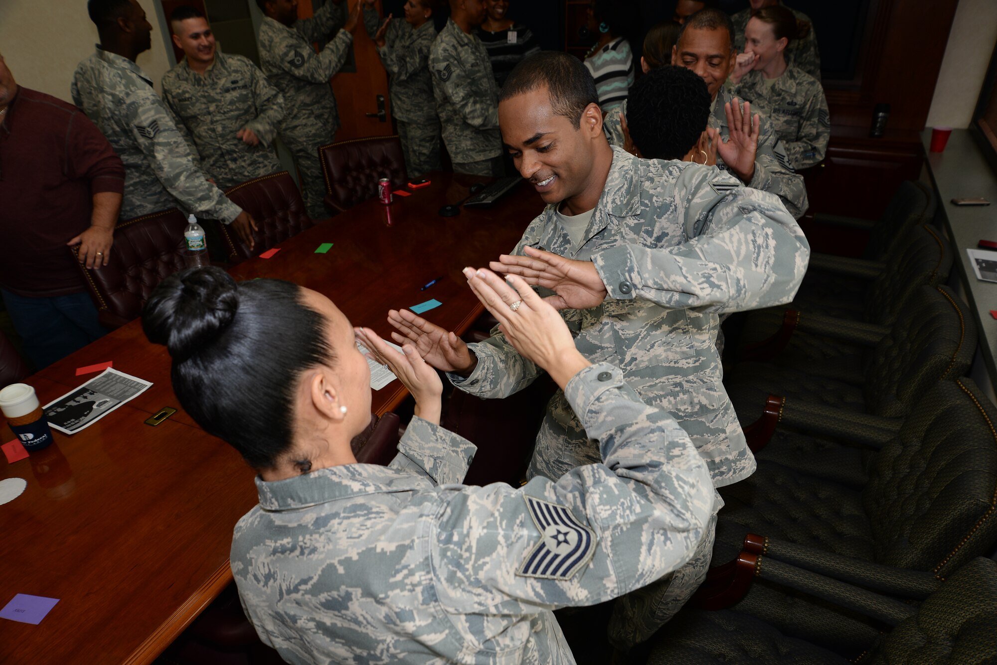 Tech. Sgt. Angela Morales, NCO in charge of the commander’s support staff, and Senior Airman Hasan Davis, departures specialist, mirror each other’s movements as part of a stress management exercise during Air Force Mortuary Affairs Operations Wingman Day Oct. 23, 2014. AFMAO’s Wingman Day focused on diversity and exploring the differences among Airmen. (U.S. Air Force photo/Master Sgt. Christopher Gish)
