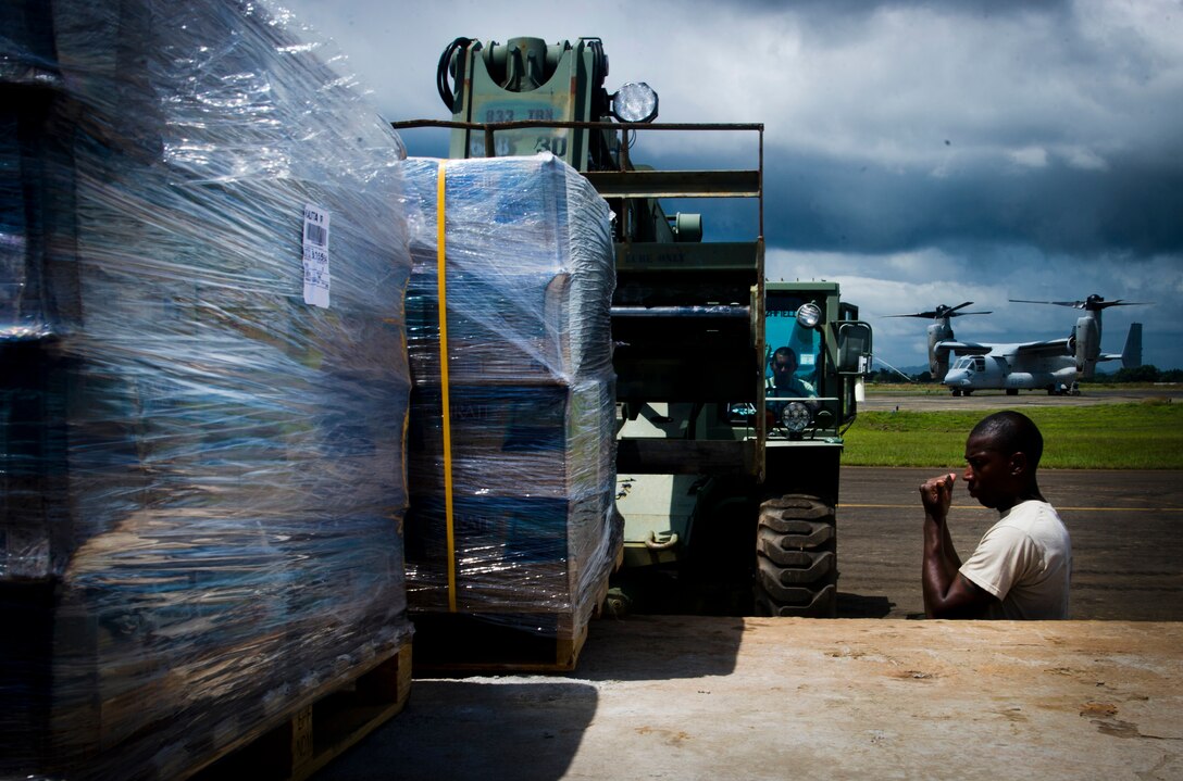 ROBERTS INTERNATIONAL AIRPORT, Republic of Liberia - U.S. Army Soldiers part of the Joint Task Force-Port Opening team of the 688th Rapid Port Opening Element assigned to Joint Base Langley-Eustis, Va., load supplies onto a truck during Operation UNITED ASSISTANCE here, October 15, 2014. The US government is increasing its assistance to help affected countries deal with the most devastating Ebola outbreak in history. (U.S. Air Force photo/Staff Sgt. Gustavo Gonzalez/RELEASED)